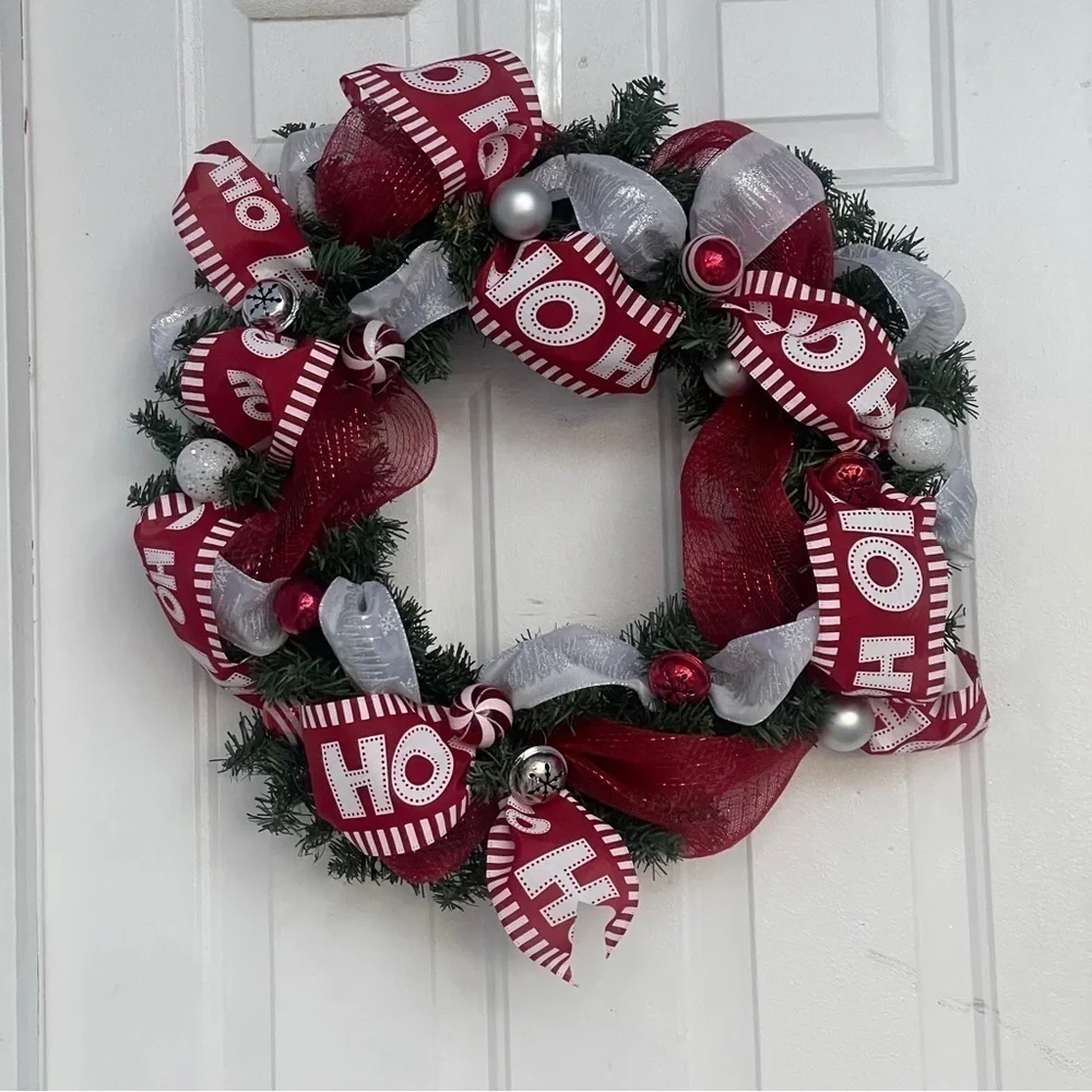 Handmade Christmas wreath, ribbon,bells, and ornaments. Silver, white and red